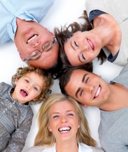Happy family lying in a circle on white floor